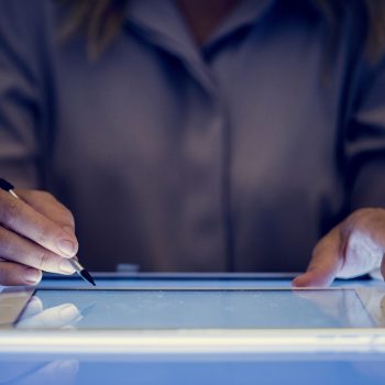 Hands holding using digital tablet on a cyber space table